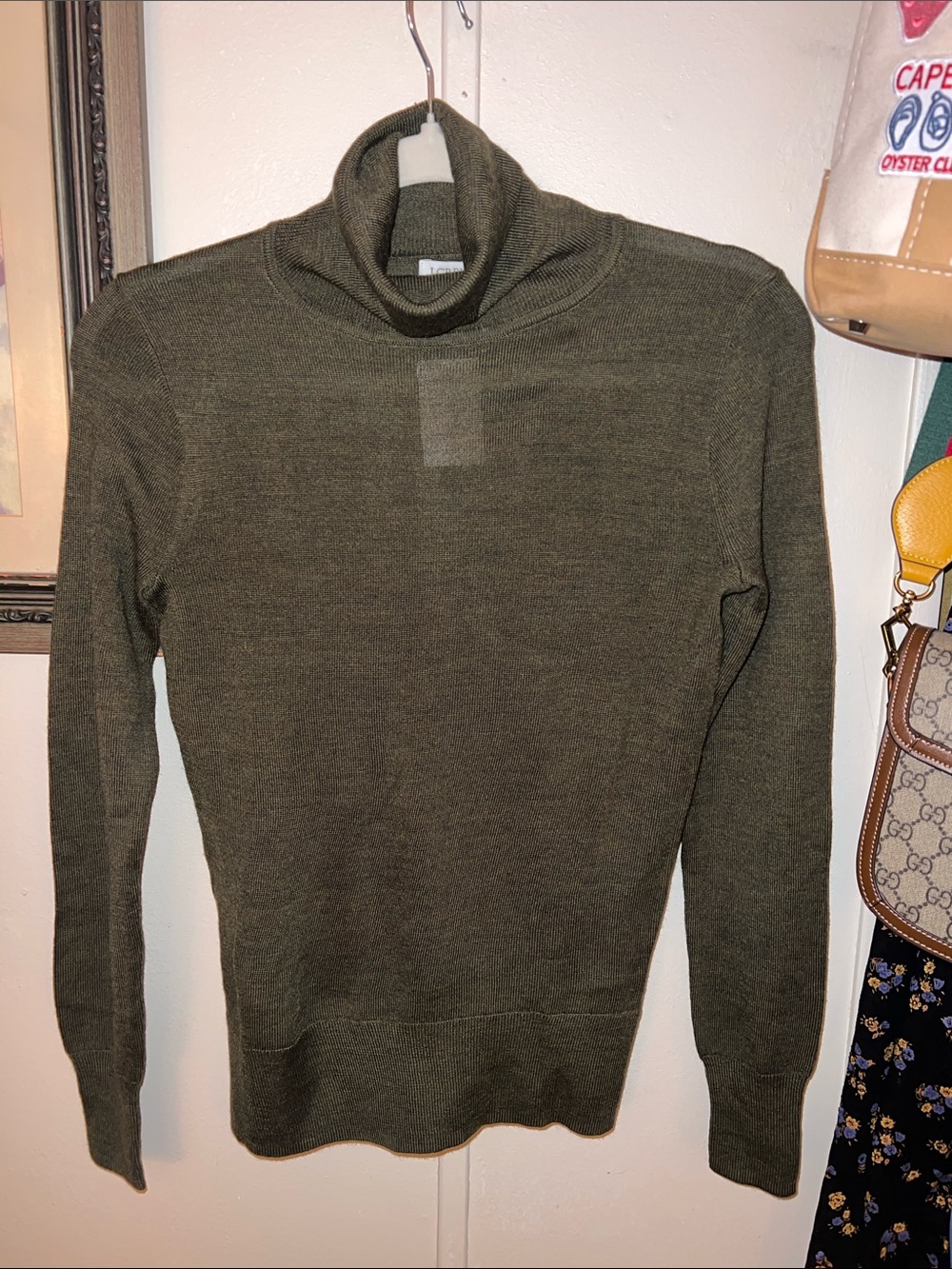 J. Crew Woman’s Olive Turtleneck Sweater. Lightweight and a year-round staple